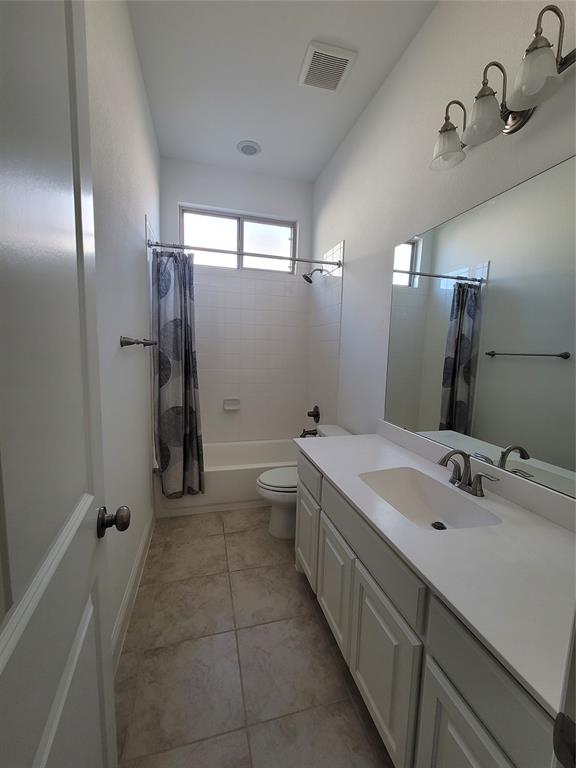 8553 Gerbera Daisy Road Frisco, TX 75035 - Photo 11 of 32 Bathroom with vanity, shower / tub combo, and light tile patterned floors