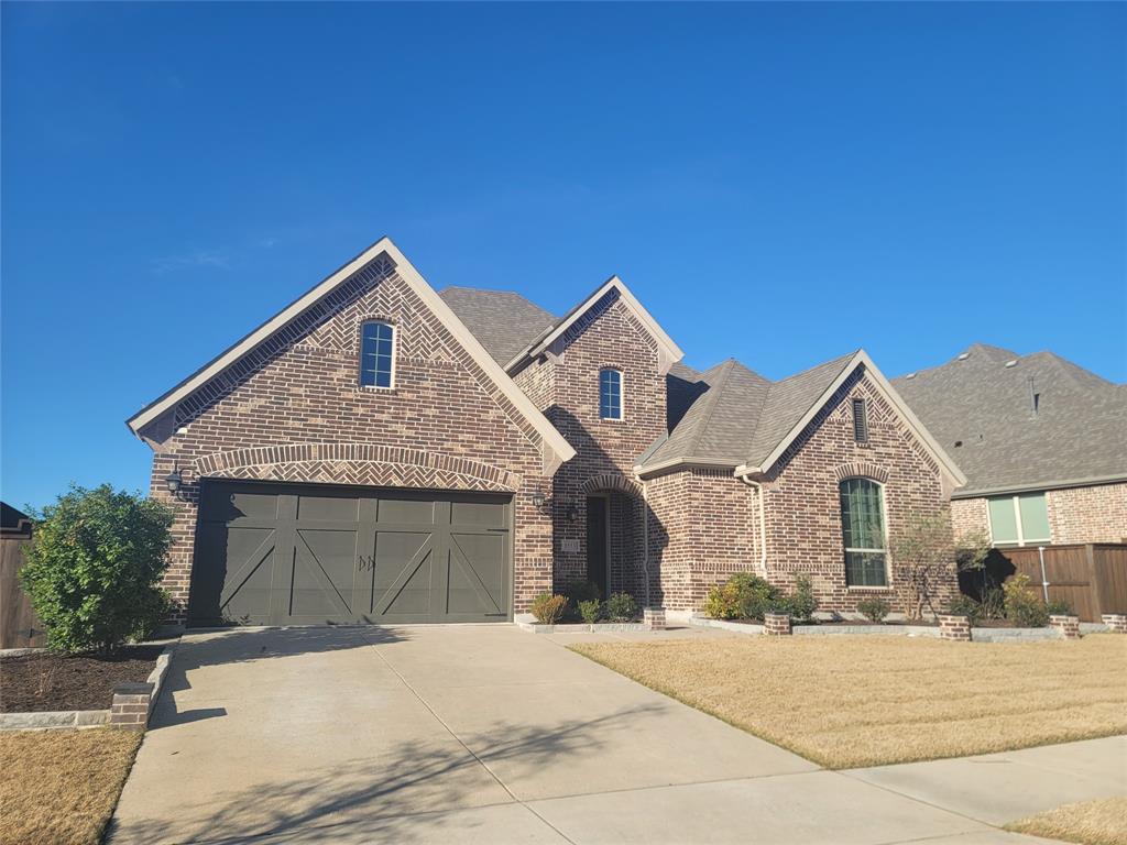 8553 Gerbera Daisy Road Frisco, TX 75035 - Photo 23 of 32 View of front of property with brick siding, driveway, a garage, and roof with shingles