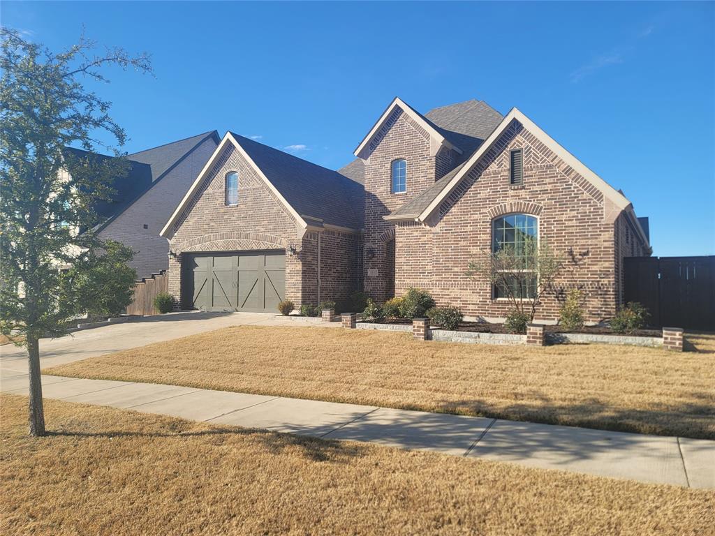 8553 Gerbera Daisy Road Frisco, TX 75035 - Photo 24 of 32 View of front of home featuring brick siding, concrete driveway, a front yard, and a garage