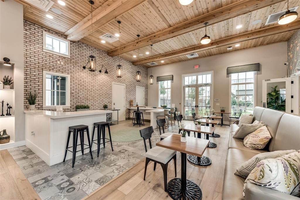 8553 Gerbera Daisy Road Frisco, TX 75035 - Photo 30 of 32 Living room with brick wall, a wooden ceiling with exposed beams, a towering ceiling, french doors, and light wood-type flooring