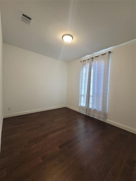 8553 Gerbera Daisy Road Frisco, TX 75035 - Photo 10 of 32 Spare room with baseboards and dark wood-type flooring