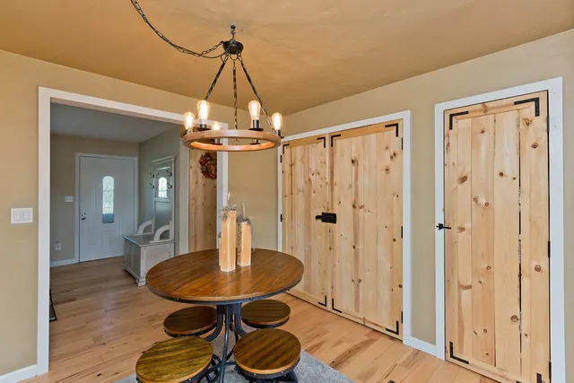 a view of a livingroom with dining room and wooden floor