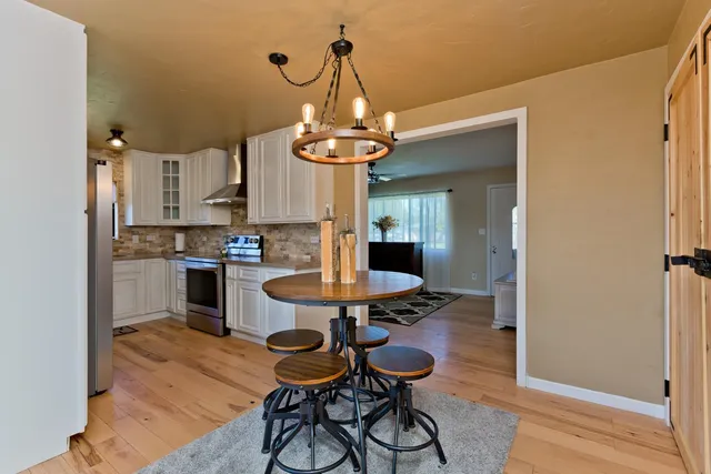 a view of a dining room with furniture wooden floor and chandelier