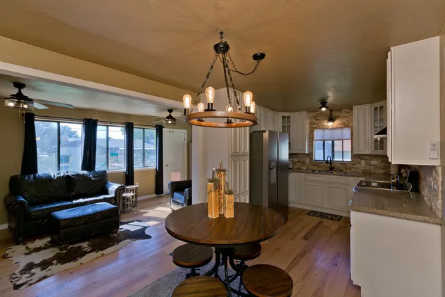 a living room with furniture and a chandelier