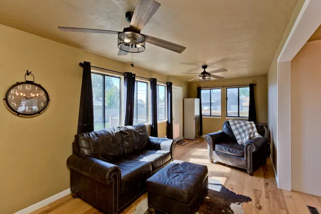 a living room with furniture chandelier and a large window