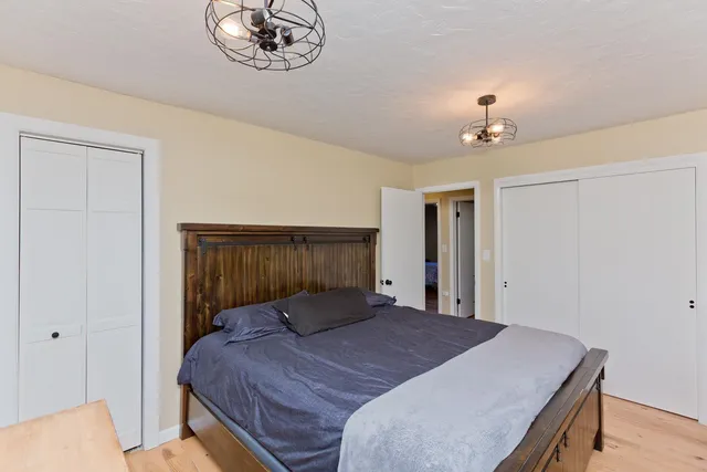 a bedroom with a bed and a chandelier