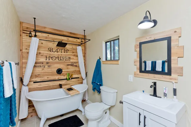 a bathroom with a sink toilet and shower