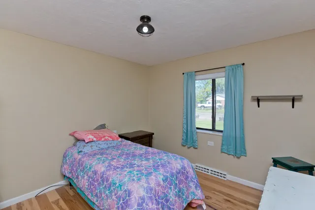 a bedroom with a bed and a dresser