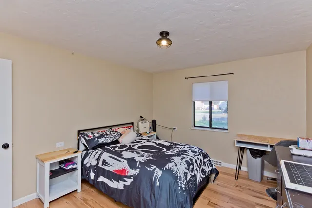 a bedroom with a bed and a window