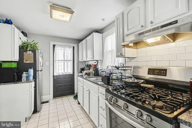 a kitchen with stainless steel appliances a stove a sink dishwasher and cabinets