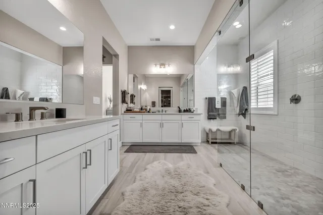 a large white kitchen with a large window