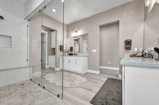 a spacious bathroom with a sink and a mirror