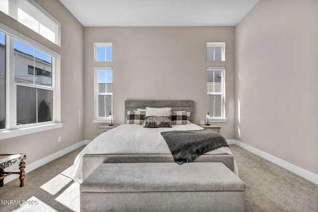 a bedroom with a bed and a large window