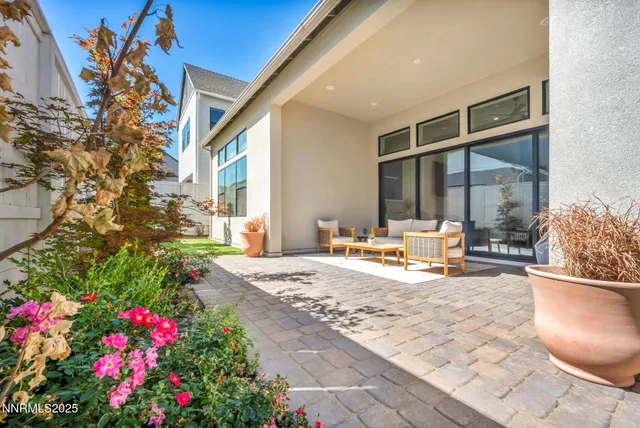 a view of a house with backyard and sitting area