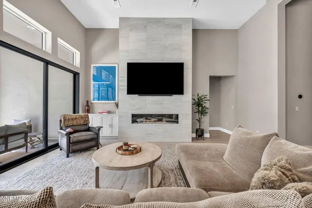 a living room with furniture a fireplace and a flat screen tv
