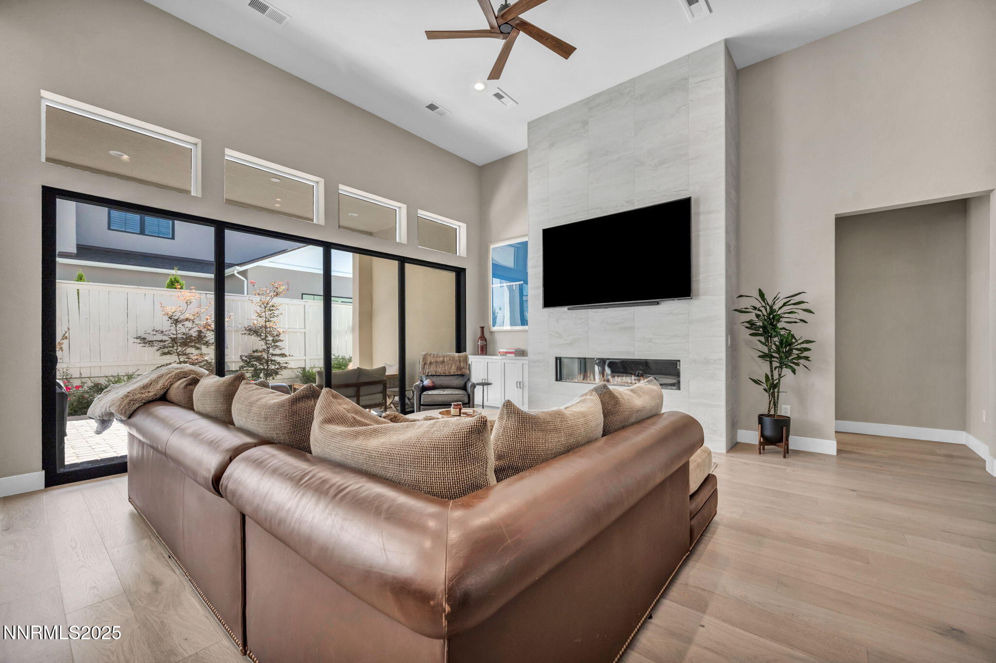 5441 Side Saddle Trail Reno, NV 89511 - Photo 4 of 25 a living room with furniture a fireplace and a flat screen tv