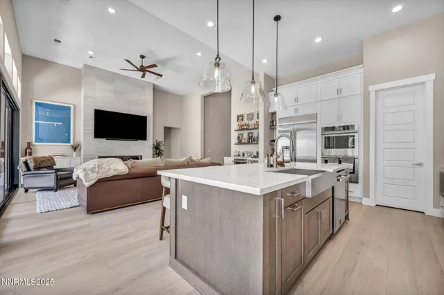 a large kitchen with stainless steel appliances kitchen island granite countertop a sink and a stove