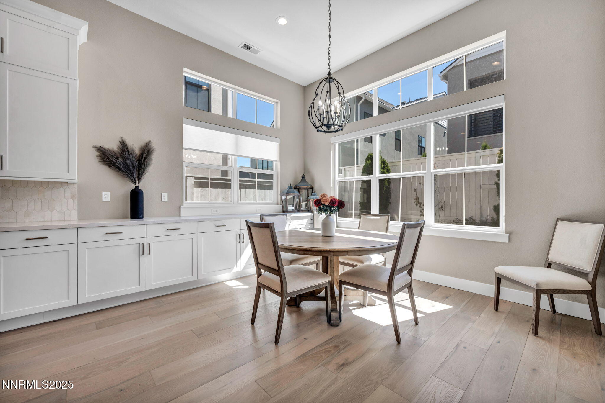 5441 Side Saddle Trail Reno, NV 89511 - Photo 8 of 25 a dining room with wooden floor a chandelier a wooden table and chairs