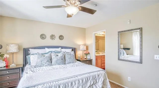 a bedroom with a bed and a painting on the wall