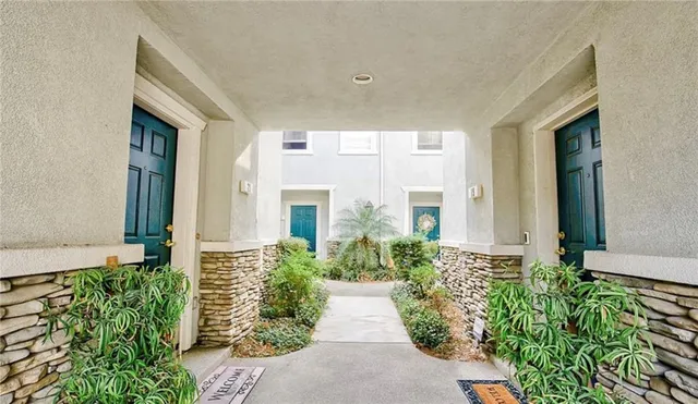 a view of a house with potted plants