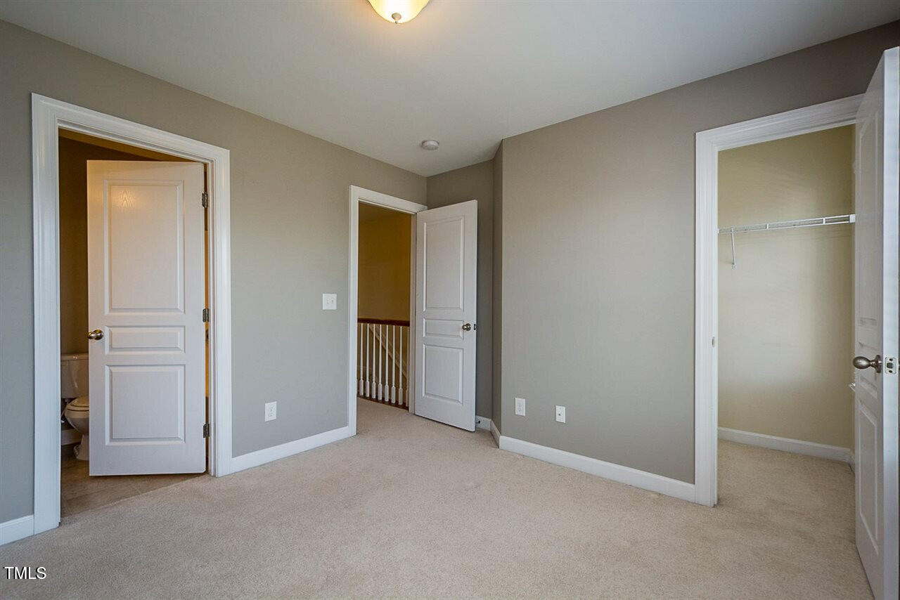 8016 Sycamore Hill Lane Raleigh, NC 27612 - Photo 13 of 19 an empty room with closet and a bathroom