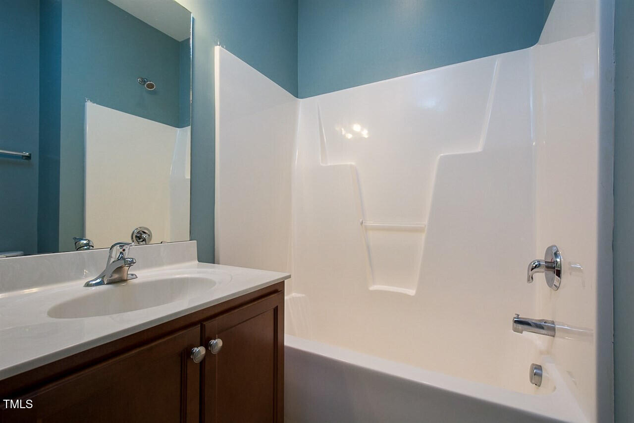 8016 Sycamore Hill Lane Raleigh, NC 27612 - Photo 17 of 19 a bathroom with a sink and a mirror