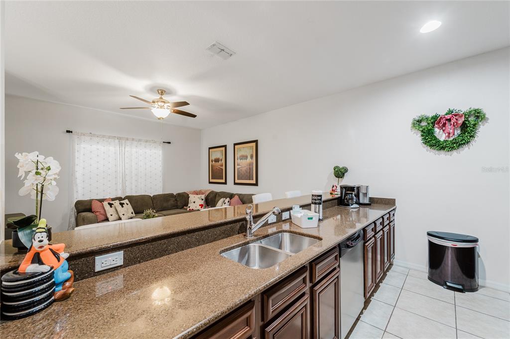 8961 Majesty Palm Road Kissimmee, FL 34747 - Photo 12 of 40 a living room with furniture and a chandelier