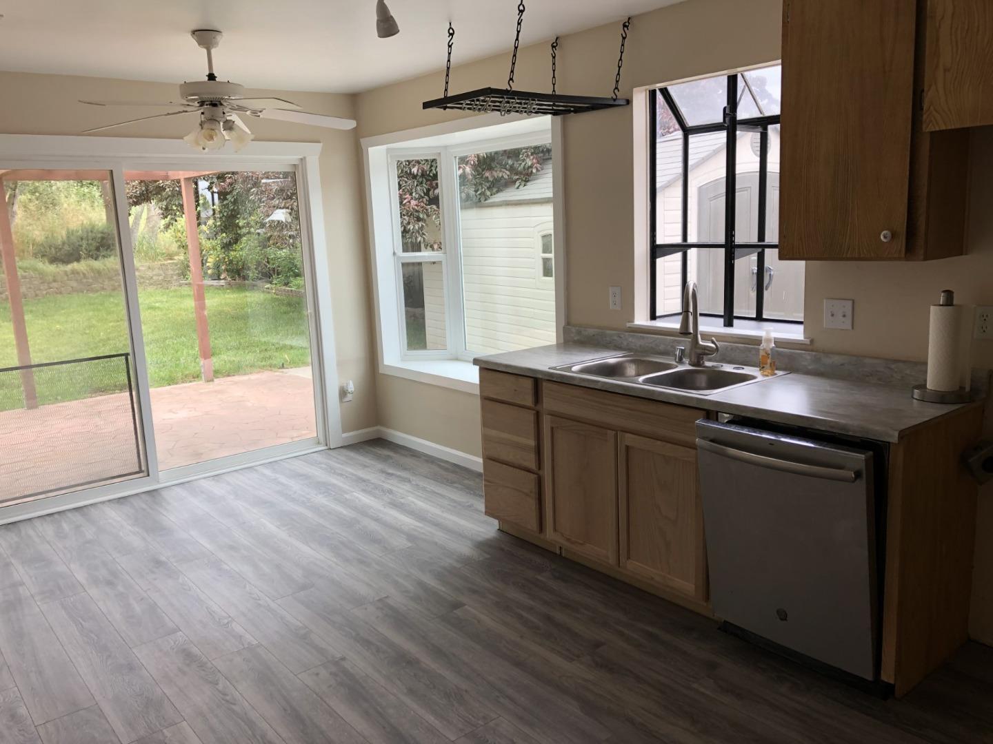 13375 Taft Circle Salinas, CA 93906 - Photo 4 of 18 a kitchen with granite countertop a stove a sink and wooden floors