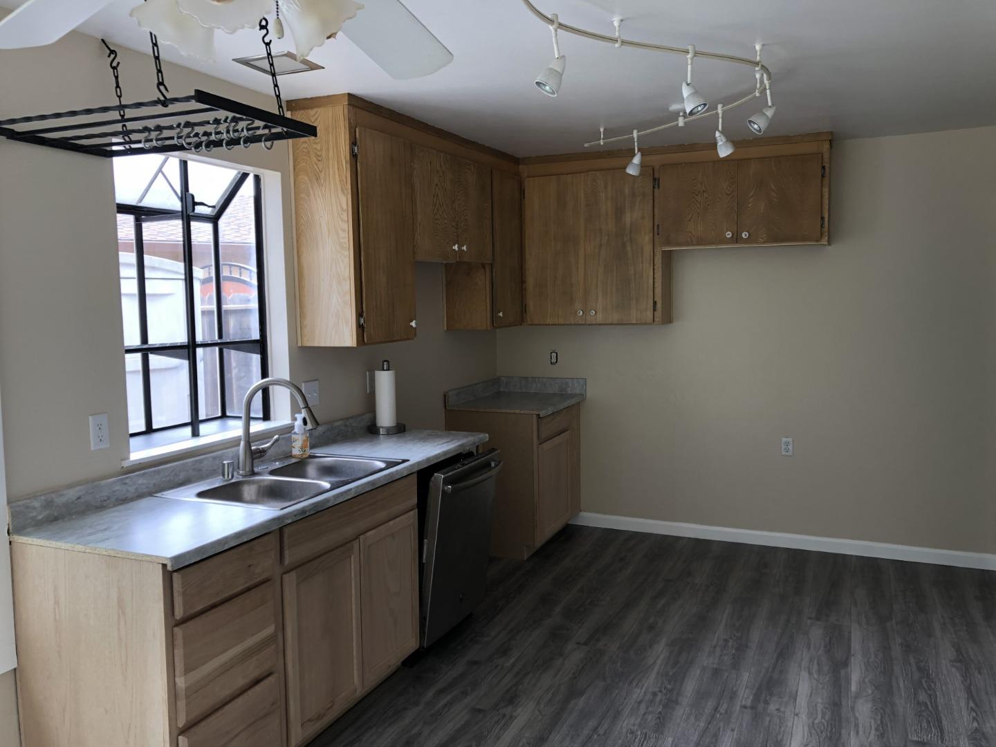 13375 Taft Circle Salinas, CA 93906 - Photo 5 of 18 a kitchen with a sink window and cabinets