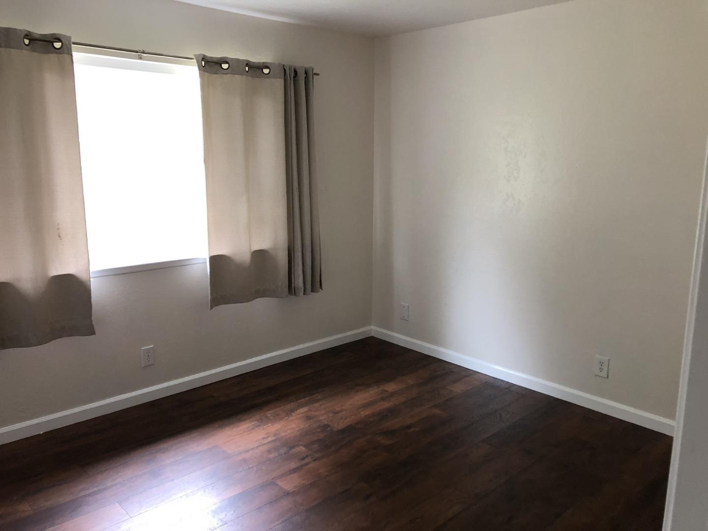 13375 Taft Circle Salinas, CA 93906 - Photo 6 of 18 a view of a room with wooden floor and a window