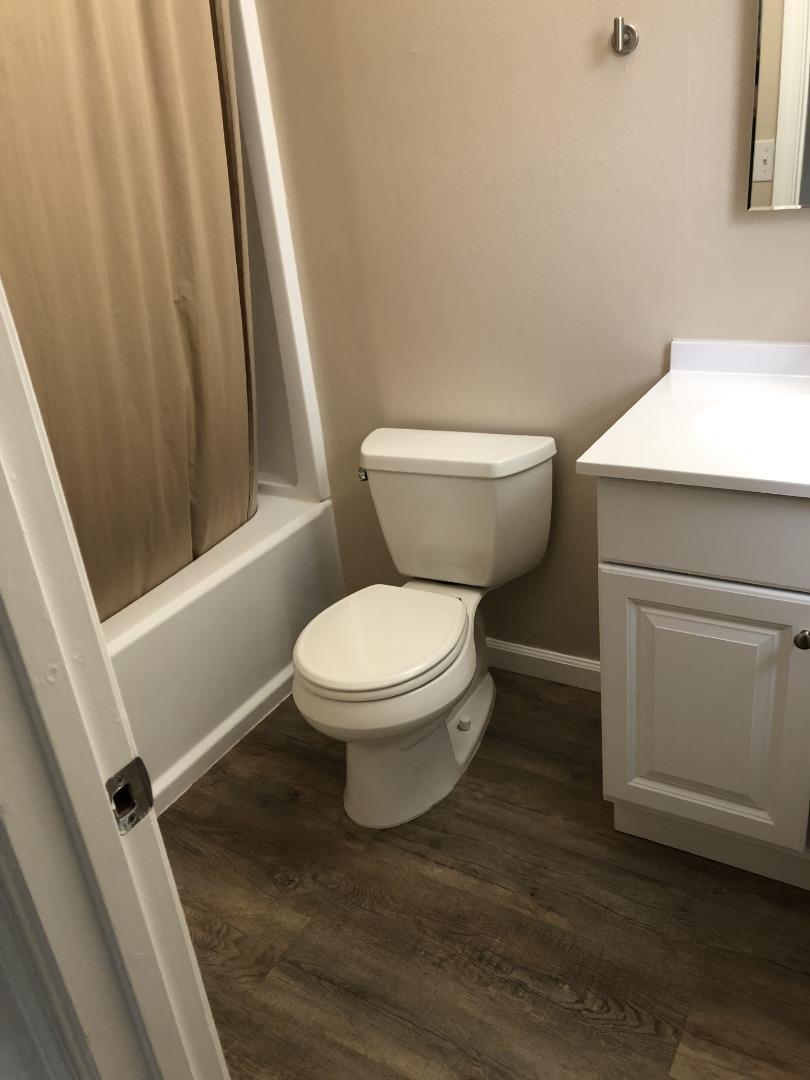 13375 Taft Circle Salinas, CA 93906 - Photo 9 of 18 a white toilet sitting next to a small sink