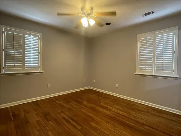 a view of a room with wooden floor and windows