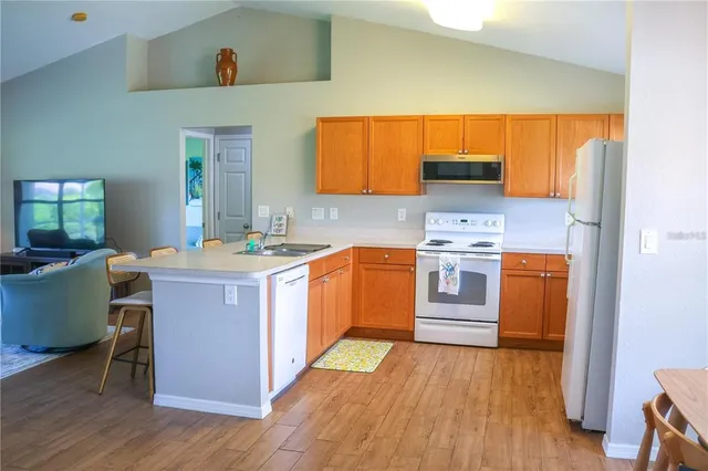 a kitchen with a sink cabinets and wooden floor
