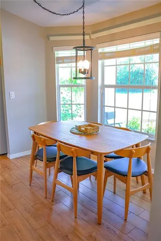 a dining room with furniture and wooden floor