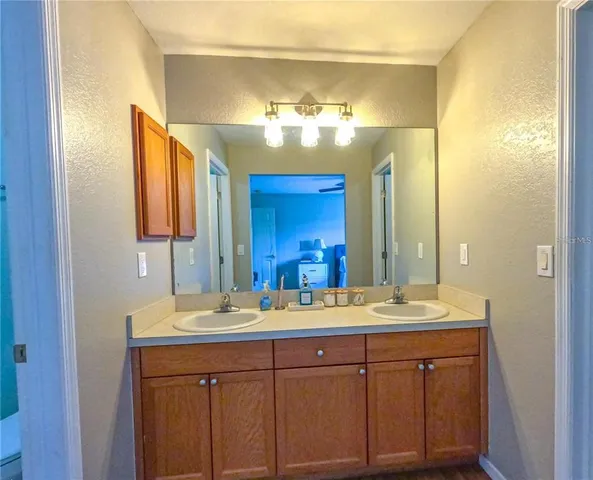 a bathroom with a double vanity sink and a mirror