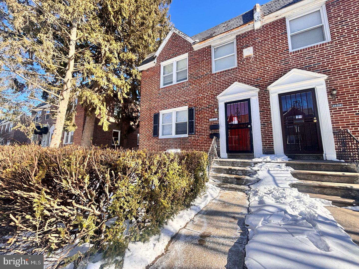 1622 Murdoch Road Philadelphia, PA 19150 - Photo 2 of 12 front view of a brick house with a large windows