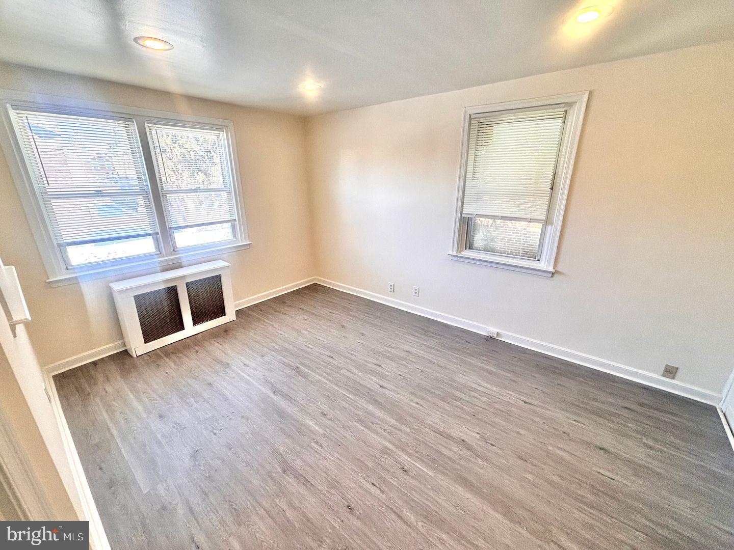 1622 Murdoch Road Philadelphia, PA 19150 - Photo 3 of 12 a view of an empty room with wooden floor and a window