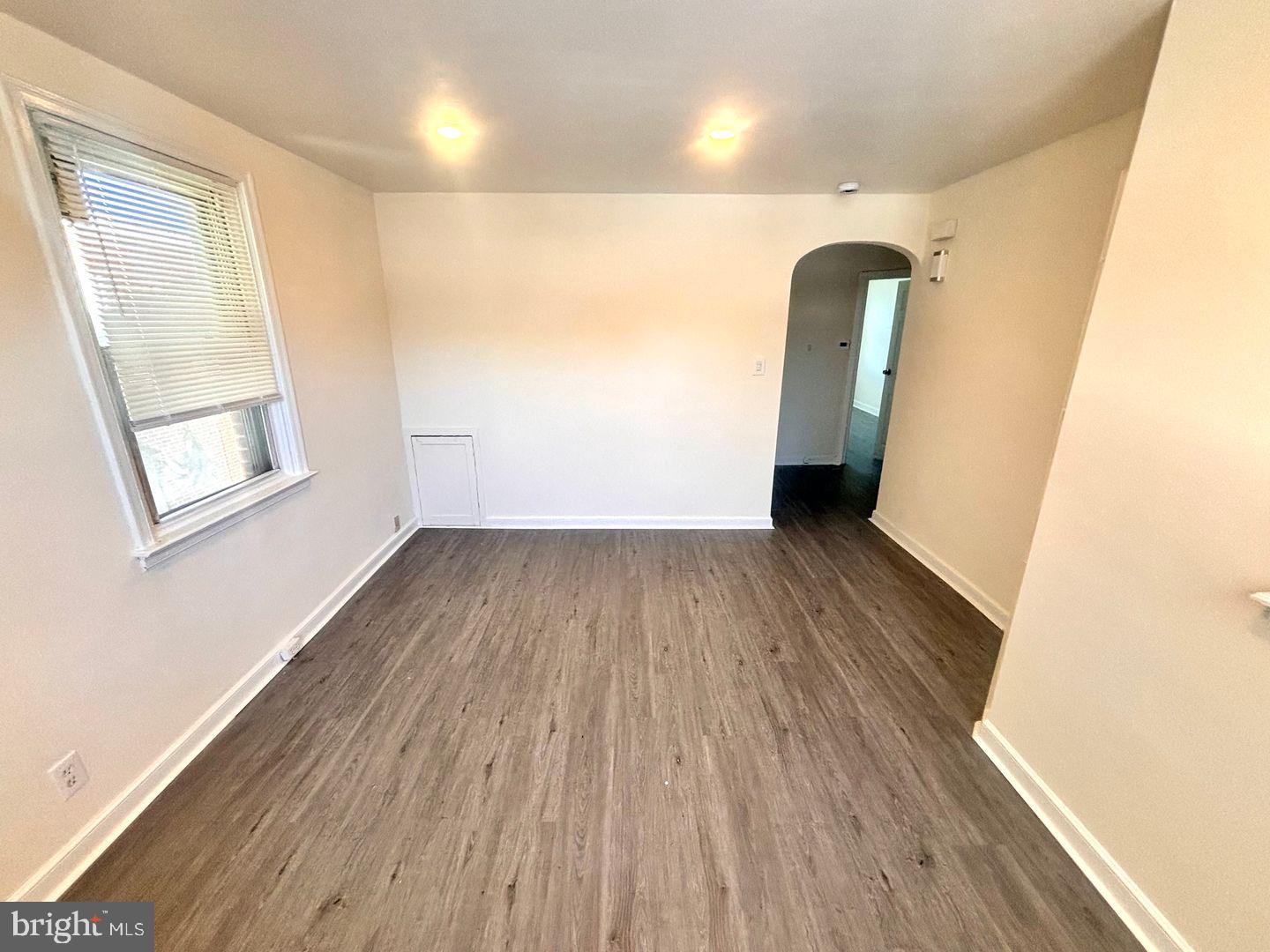 1622 Murdoch Road Philadelphia, PA 19150 - Photo 10 of 12 an empty room with wooden floor and windows