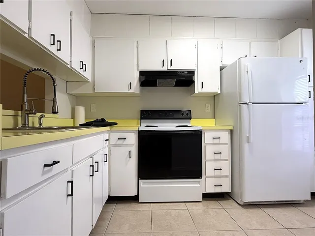 a kitchen that has a stove and a microwave