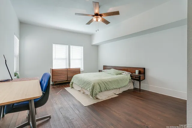 a bedroom with a bed a table and chair