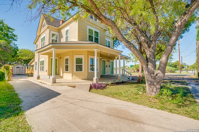 a front view of a house with garden and porch