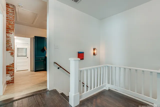 a view of a hallway with wooden floor and entryway