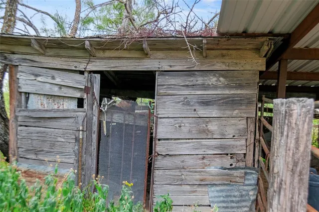 a living room with furniture a chandelier and a large window
