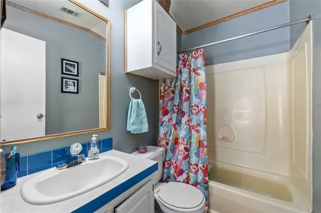 a patio with table and chairs and potted plants