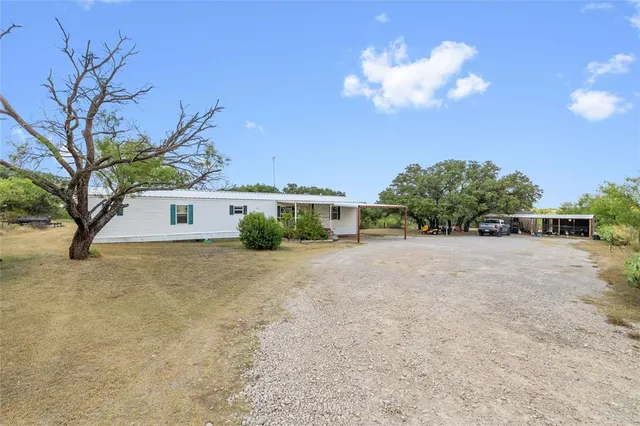 a view of a patio with table and chairs potted plants with wooden floor