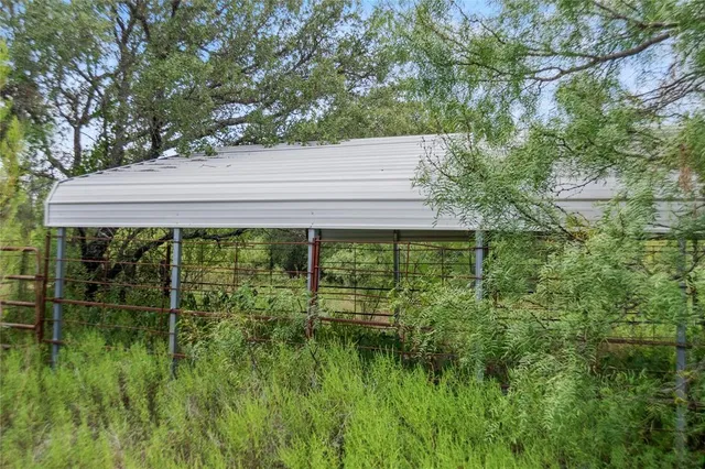 a view of house with outdoor seating and garden