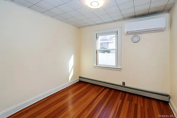a view of a room with wooden floor and fan