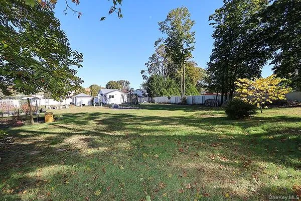 a view of a field with large trees