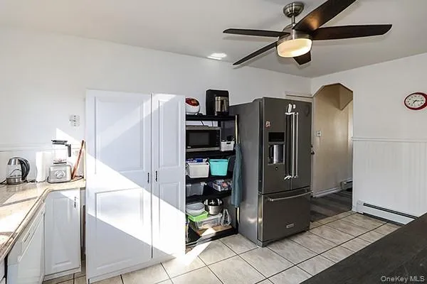 a kitchen with stainless steel appliances kitchen island granite countertop a refrigerator and a sink