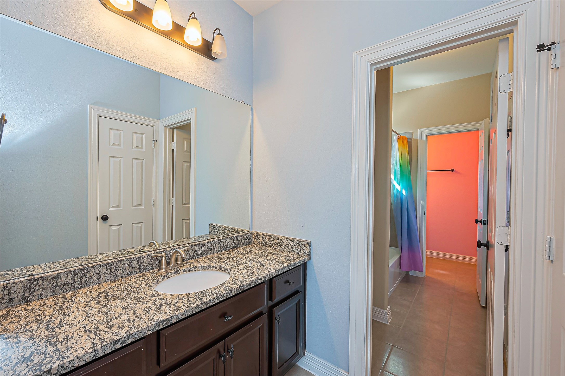 10018 Durango Path Lane Cypress, TX 77433 - Photo 25 of 50 This stylish en-suite bathroom seamlessly connects for convenience and privacy.